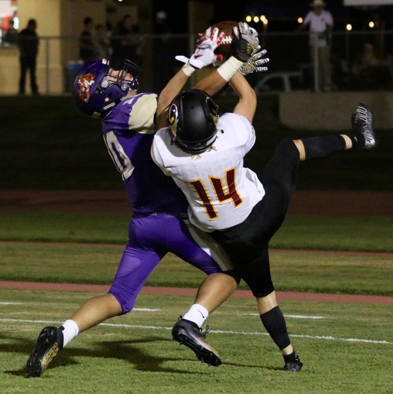 Lemoore's Koy Davis grabs interception from hands of Tulare's Pedro Hernandez in the end zone Friday night. Davis had two interceptions in Lemoore's non-league loss to Tulare Union.